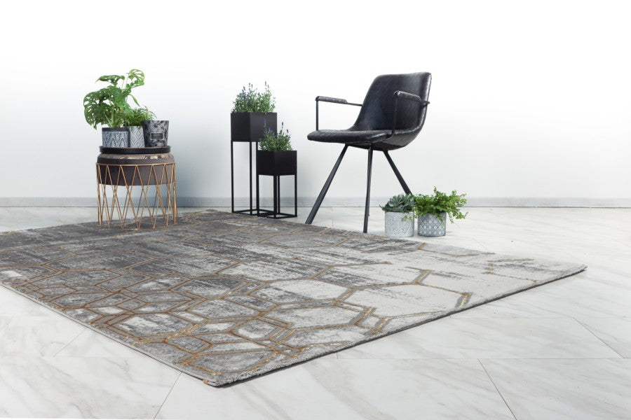 grey gold rug with black chair