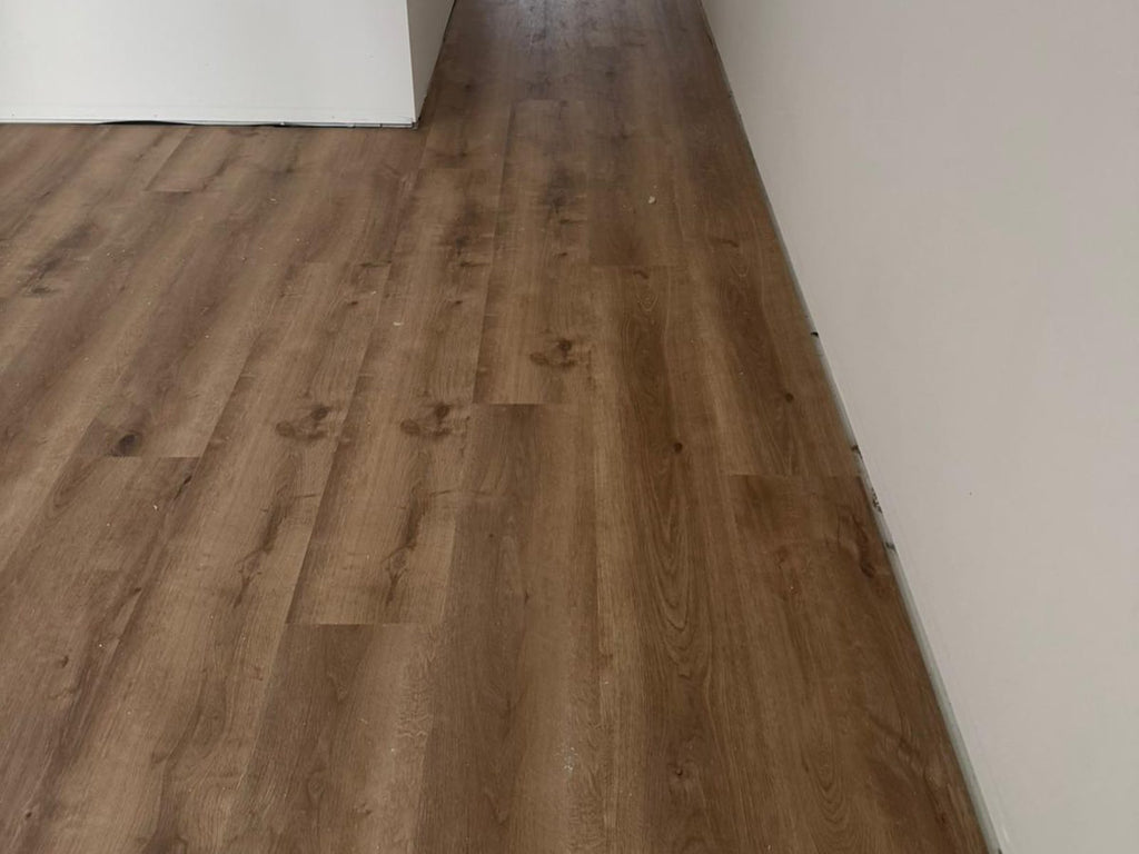 Hallway finished in a grey-brown timber-look plank floor
