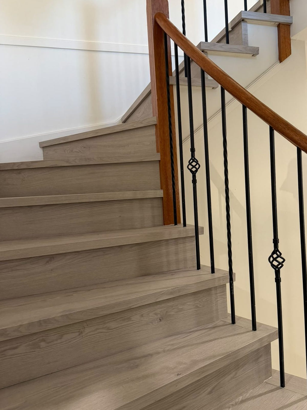 Staircase clad in grey-toned timber-look planks with nosing on each step, laid by Adore