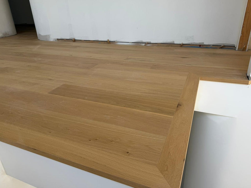 Warm oak wide boards on a stair landing with edge nosing