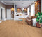 Lounge with a tan leather sofa on a light honey-tan timber floor with straight grain