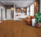 Lounge with a tan leather sofa on a deep reddish orange-brown timber floor