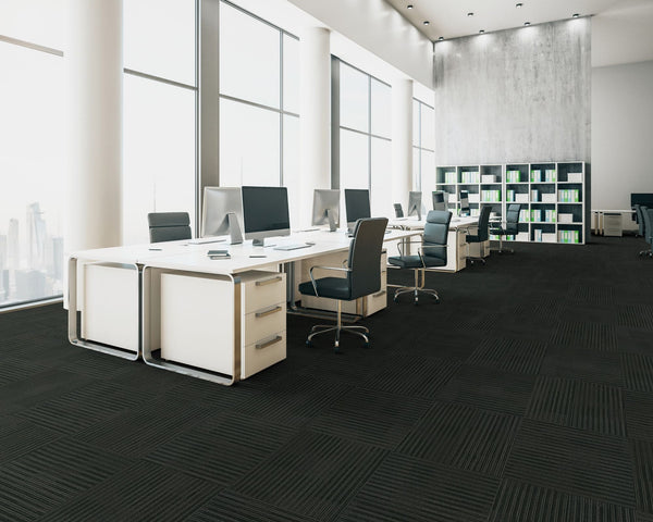 Office floor of near black loop pile carpet tiles with a subtle linear texture