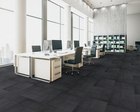 Office floor of black carpet tiles with navy and blue-grey stripes laid quarter turn