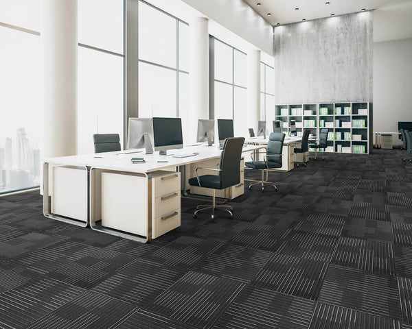 Office floor of black and charcoal carpet tiles with white-grey stripes in a quarter turn chequer