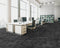 Office floor of black and charcoal carpet tiles with white-grey stripes in a quarter turn chequer