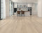 Kitchen with a pale whitewashed greige laminate plank floor