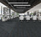 Office floor of charcoal carpet plank tiles with blue accent threads