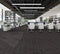 Office floor of charcoal carpet plank tiles with dark red accent threads