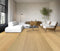 Living room with a white sofa on a light honey blonde oak floor with straight grain