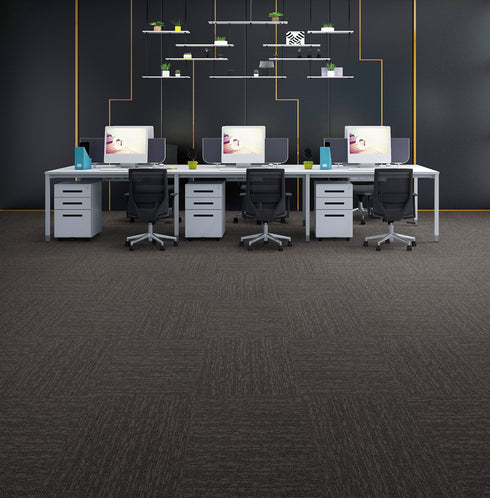 Office laid with dark charcoal cushion-backed carpet tiles with brownish-taupe streaks