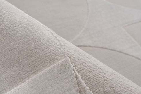 - Contemporary grey area rug featuring a repeating pattern of circles and triangles