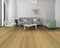 Lounge with a grey sofa and green chair on a golden honey oak floor with knots
