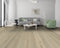 Lounge with a grey sofa and green chair on a whitewashed grey-white oak floor