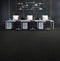 Office laid with near black cushion-backed carpet tiles