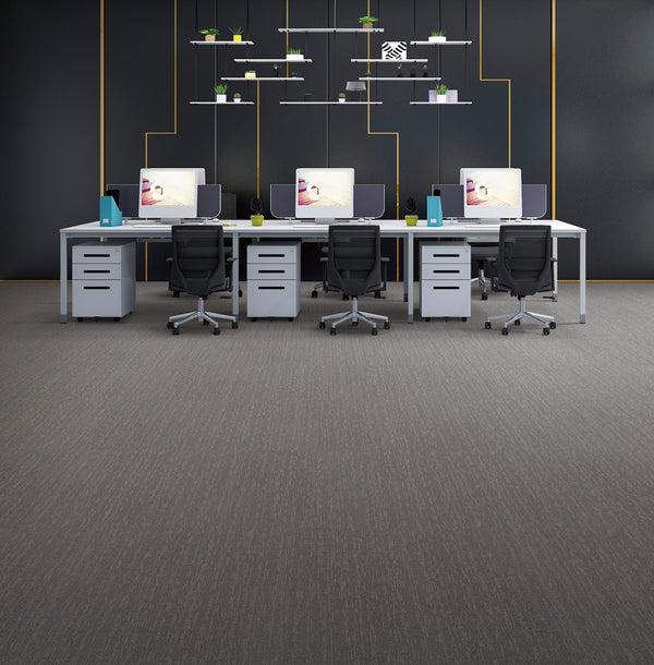 Office laid with mid grey cushion-backed carpet tiles with a linear texture