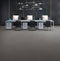 Office floor of mid grey carpet tiles with a linear texture
