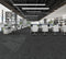 Office floor of charcoal carpet plank tiles with lighter grey threads