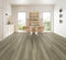 A mid taupe-grey hybrid plank floor with streaks in a dining room with timber chairs