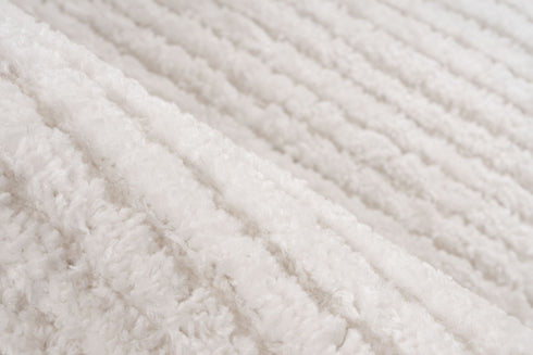 Plush ivory rug featuring subtle linear pattern and cozy surface