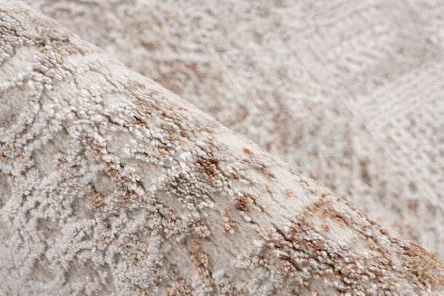 Elegant beige and brown rug with worn, textured design