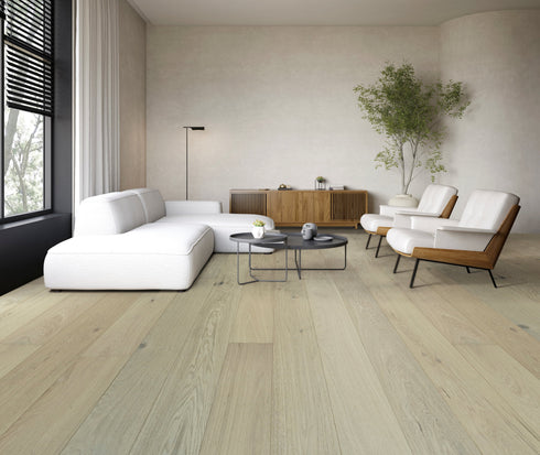 Whitewashed greige oak floor under a white sofa in a living room
