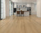 Kitchen with a light to mid beige laminate plank floor