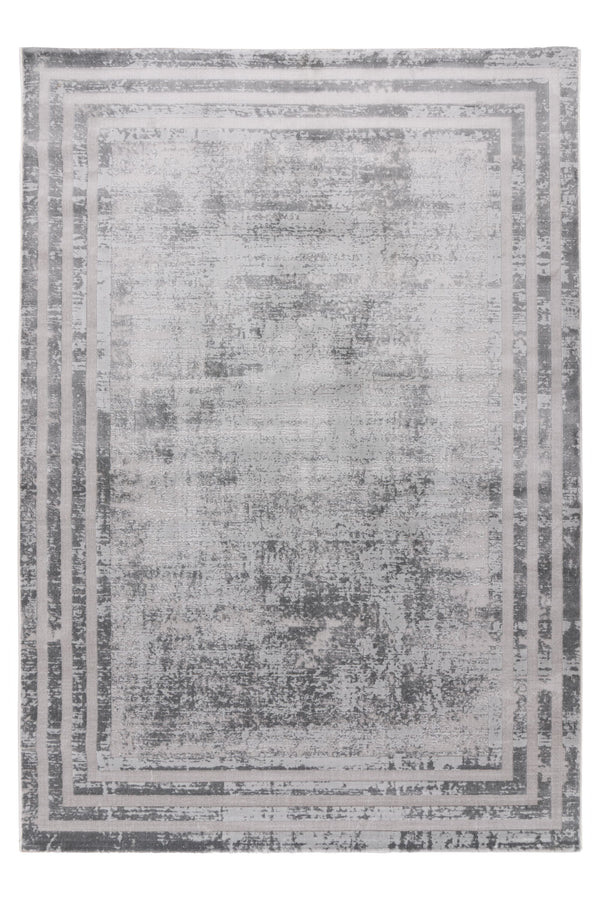 Grey area rug with distressed vintage-style borders