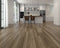 Kitchen with a grey-brown laminate plank floor with darker streaks