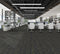Office floor of charcoal carpet plank tiles with yellow-olive gold accent threads