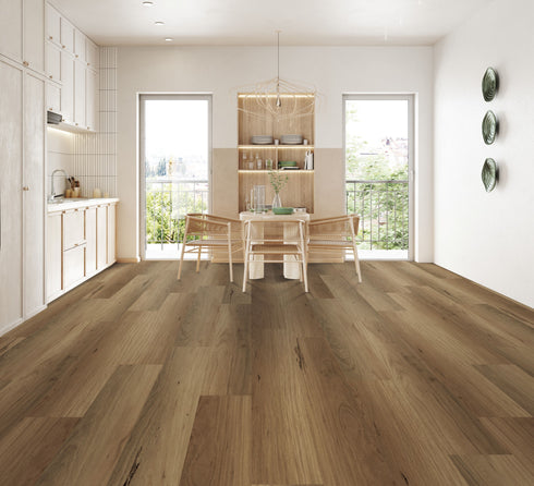 A mid warm brown hybrid plank floor with dark gum veins in a dining room with timber chairs