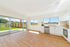Ornato Tivoli 5.3mm looselay vinyl plank in light honey oak, shown installed through an open plan kitchen and living area