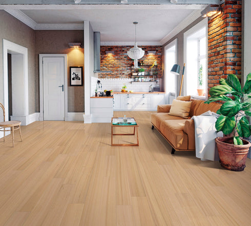 Lounge with a tan leather sofa on a pale pinkish blonde floor of wide timber boards