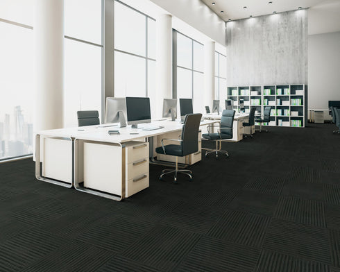 Office floor of near black loop pile carpet tiles with a subtle linear texture