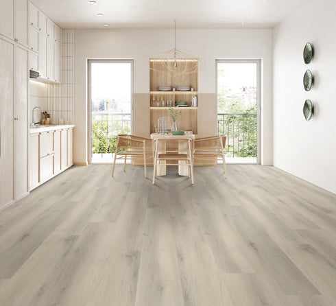 A pale grey-beige hybrid plank floor with cathedral grain in a dining room with timber chairs