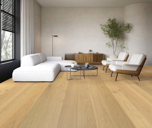 Living room with a white sofa on a light honey blonde oak floor with straight grain