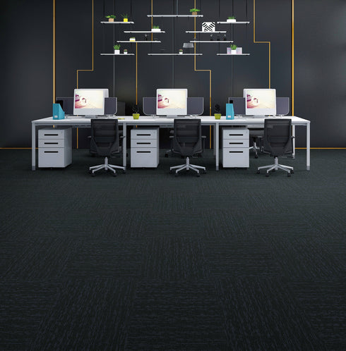 Office floor of very dark carpet tiles with a teal blue-green cast