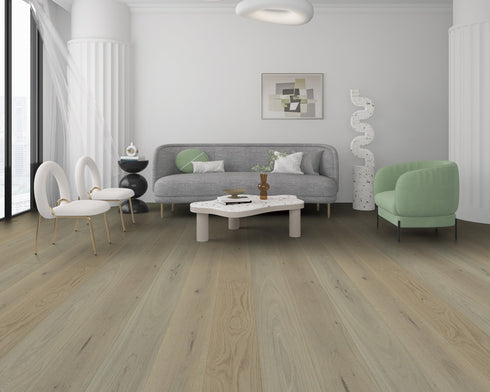 Lounge with a grey sofa and green chair on a cool grey-beige oak floor