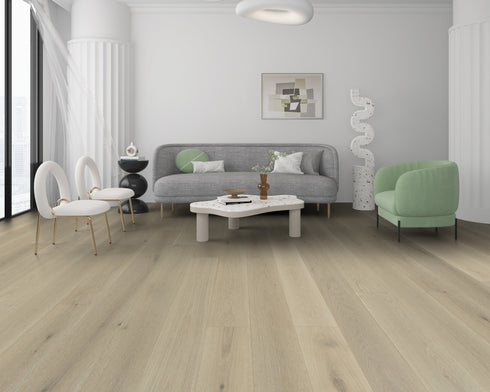 Lounge with a grey sofa and green chair on a whitewashed grey-white oak floor